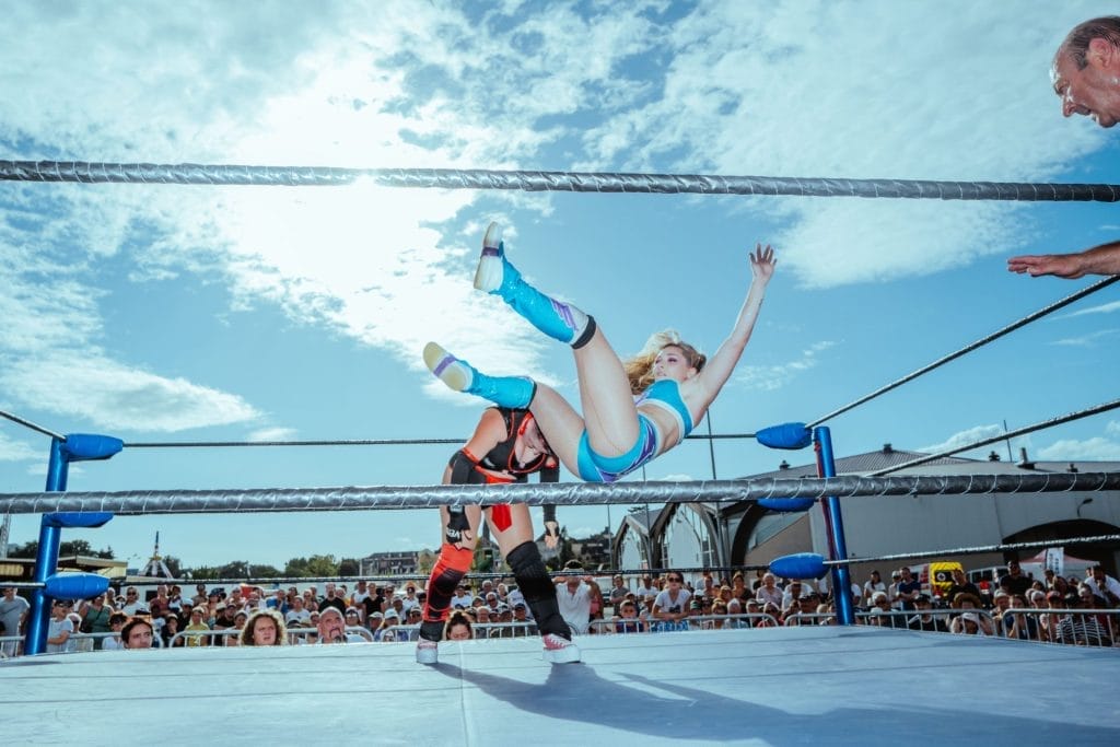 Sur un ring monté quelques heures plus tôt au Parc Saint-Fiacre de Château-Gontier, les catcheuses Miss Pauline (en bleu) et Angel’s Bombita (en rouge et noir) s’affrontent en duel © Louise Quignon